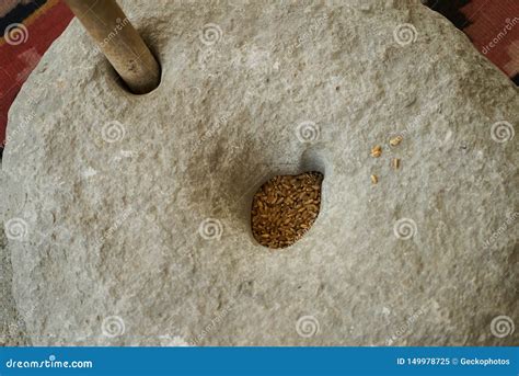 The Ancient Quern Stone Hand Mill With Grain Close Up Stock Image