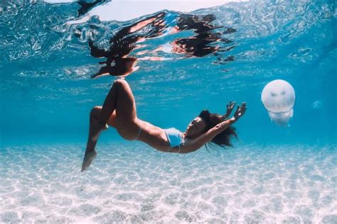 Naked Woman Free Diver Glides Over Sandy Sea With Fins Freedivi