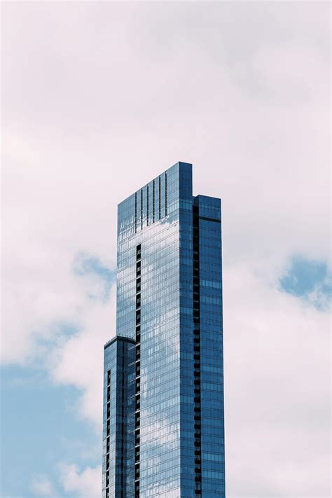 High Rise Glass Skyscraper Against Blue Sky · Free Stock Photo