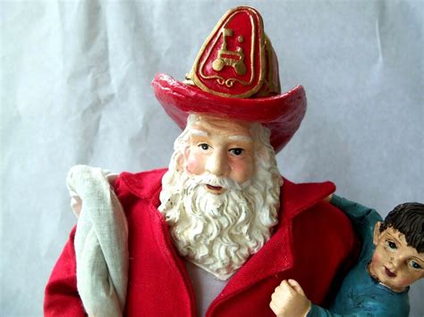 Fireman Santa Holding Child Figure 12 12 Tall Fire Hose Fire Hat