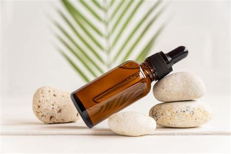 Premium Photo Bottle Of Dark Amber Glass With Essential Oil Or Face