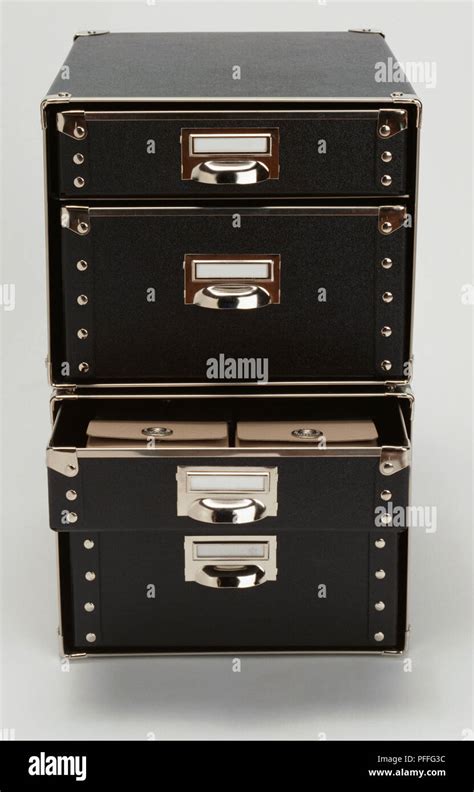 Black fibreboard storage box with four drawers one open Stock Photo - Alamy