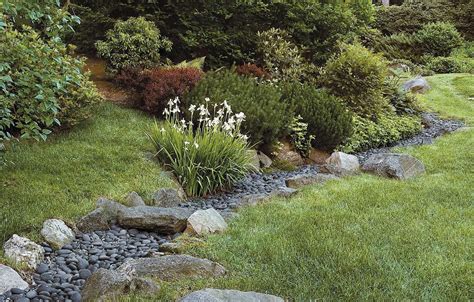 This river of rocks, AKA a drainage swale, will prevent flooding in ...