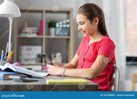 Girl With Smartphone Distracting From Homework Stock Photo Image Of