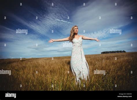 Woman Standing With Arms Outstretched In Wheat Field Stock Photo Alamy