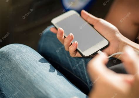 Free Psd Close Up Of Hands Charging Mobile Phone