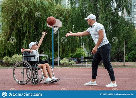 Dad Plays With His Disabled Son On The Sports Ground Concept