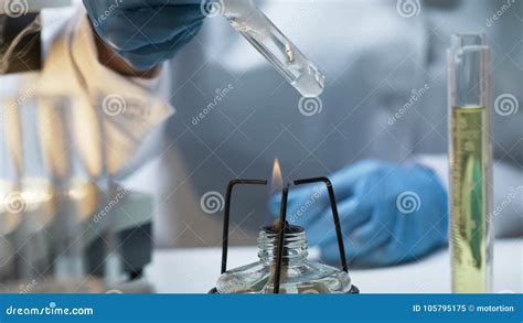 Scientist Holding Tube with Boiling Fuming Liquid Over Burner, Lab ...