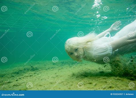 A Floating Woman Underwater Portrait Girl In White Dress Swimming In