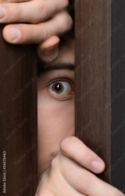 Men Peeking Close Up Of Men Peeking Through The Open Door Stock Photo