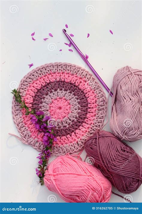 Colorful Round Crochet Pattern With Flowers On White Table Handmade