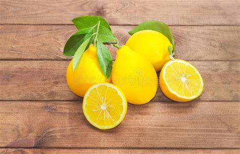 Several Whole Lemons And One Lemon Cut In Half Stock Photo Image Of