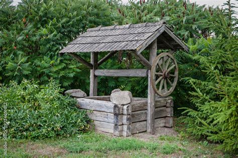 Old water well with pulley. Wooden water well in village. Lithuania. Stock Photo | Adobe Stock