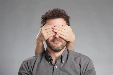 Cropped Image Of Hand Covering Man Eyes Against White Background ...