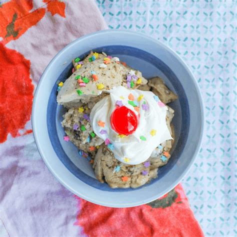 A Bowl Filled With Ice Cream And Sprinkles On Top Of A Table