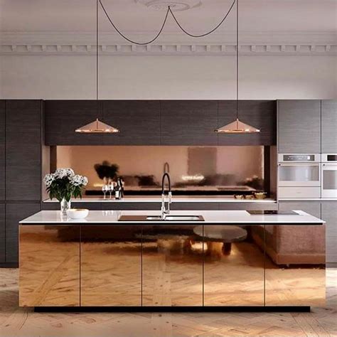 A Modern Kitchen With Stainless Steel Appliances And Wood Flooring