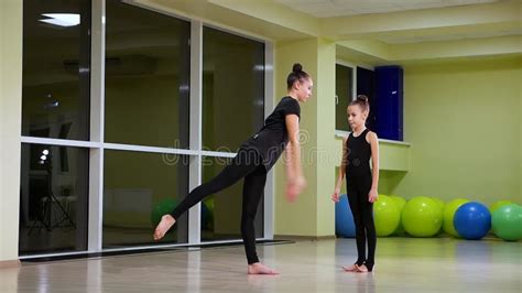 Close Up Two Slim Cute Sisters Artistic Gymnasts In Black Sportswear