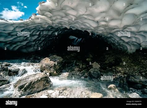 Opening of an ice cave with rocks in Kamchatka Peninsula, Russia Stock ...