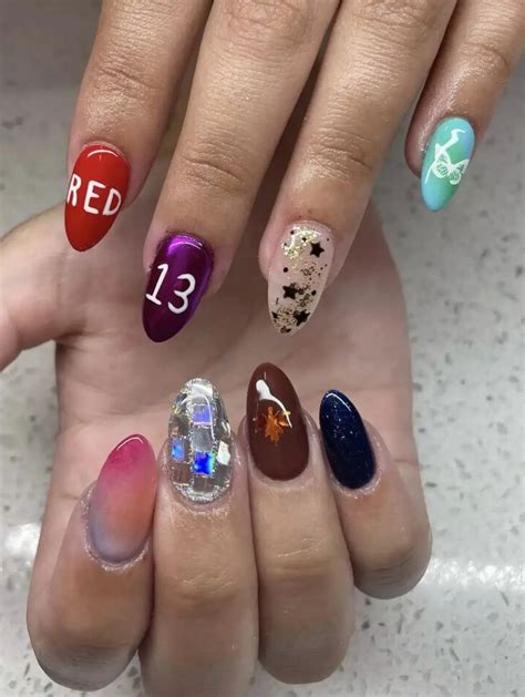 Four Different Colored Nail Polishes With The Numbers Thirteen And Thirteen On Each One Hand