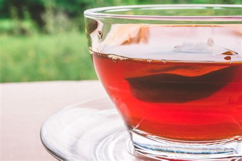 Premium Photo A Cup Of Tea On The Wooden Table Tea Bag In Glass