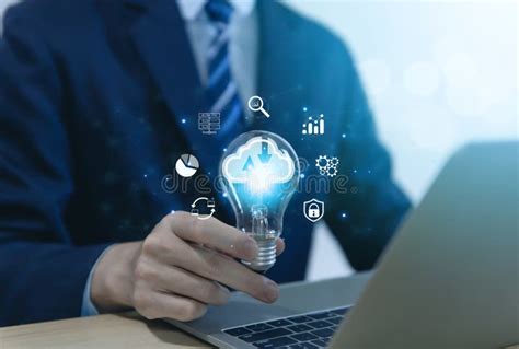 Businessman Holding A Light Bulb Showing A Diagram Of Cloud Computing