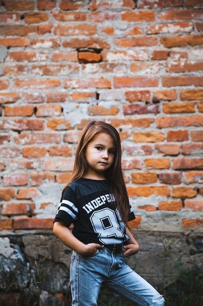 Hermosa niña en jeans rasgados niño de moda Foto Premium