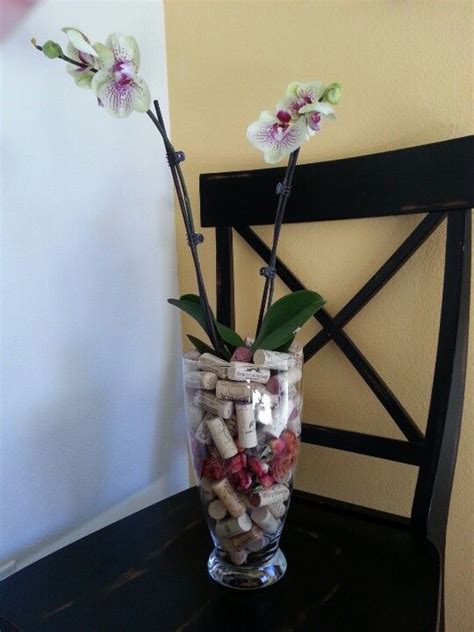 Orchid In Glass Vase With Mini Dried Roses And Wine Corks Wedding Flowers Orchids Orchid Pot