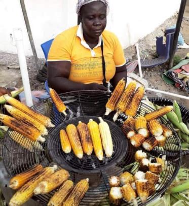 Trending Photo Of Corn Seller Selling Roasted Corn In Bits