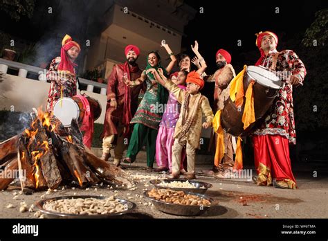 Family celebrating Lohri festival, Punjab, India Stock Photo - Alamy