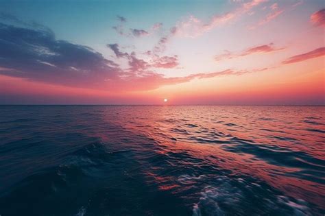 Premium Photo A Serene Sunset Over Calm Ocean Waters