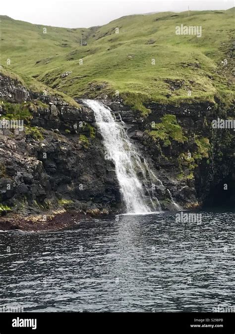 A waterfall cascading down a cliff, Streymoy, Faroe Islands Stock Photo ...