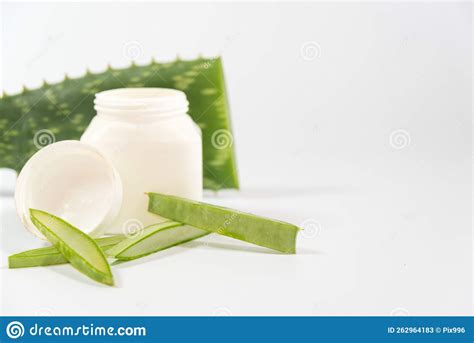 Pieces Of Aloe Vera Leaves And A Plastic Container On A Table Stock