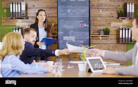 Young Business Woman In Suit Having A Successful Presentation In Front