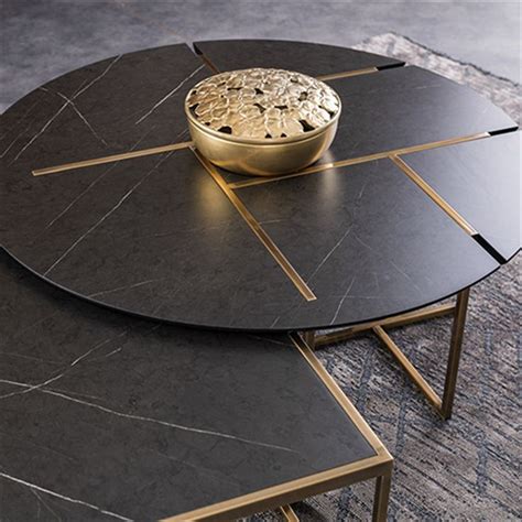 Two Tables With Black Marble And Gold Accents On Each Table One Has A