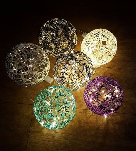 Four Decorative Lights Sitting On Top Of A Wooden Floor