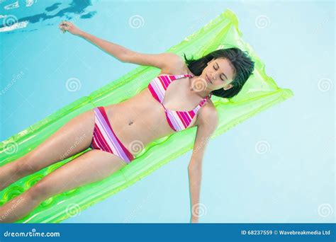 Beautiful Woman In Bikini Lying On Air Bed In Swimming Pool Stock Image