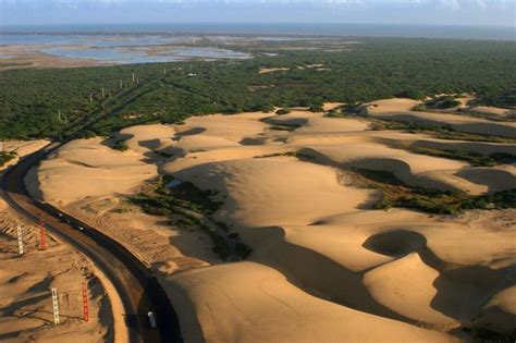 An Aerial View Of Sand Dunes In The Desert