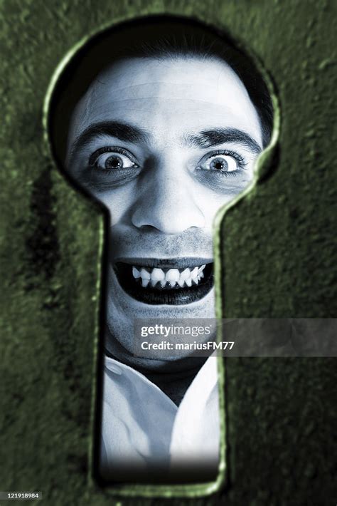 Madman Looking Through Keyhole High Res Stock Photo Getty Images