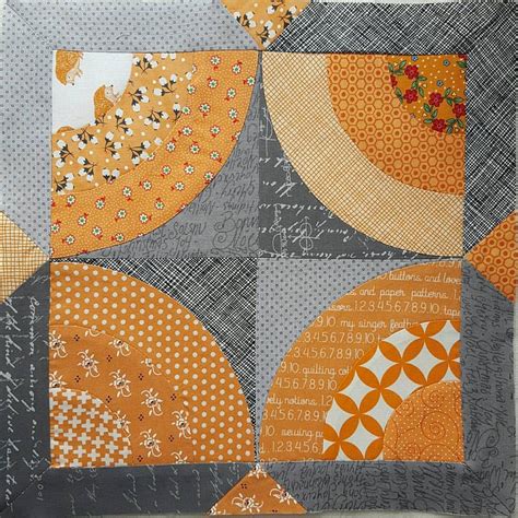 An Orange And Gray Patchwork Quilt With Circles