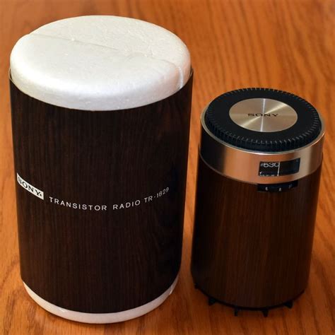 a black and white container sitting on top of a wooden table next to a ...