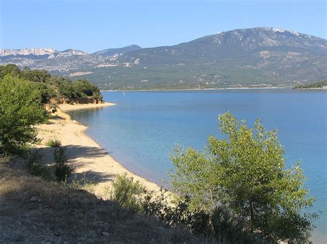 A Large Body Of Water Surrounded By Mountains