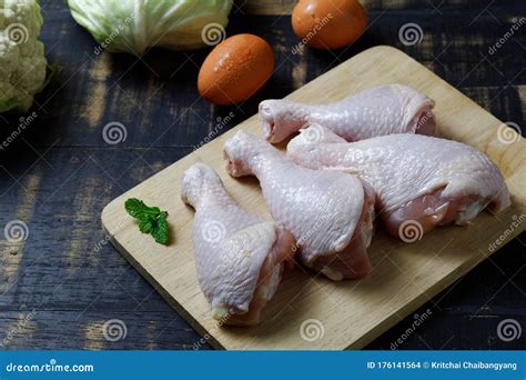 Fresh Raw Chicken Drumsticks With Skin On Cutting Board Stock Photo