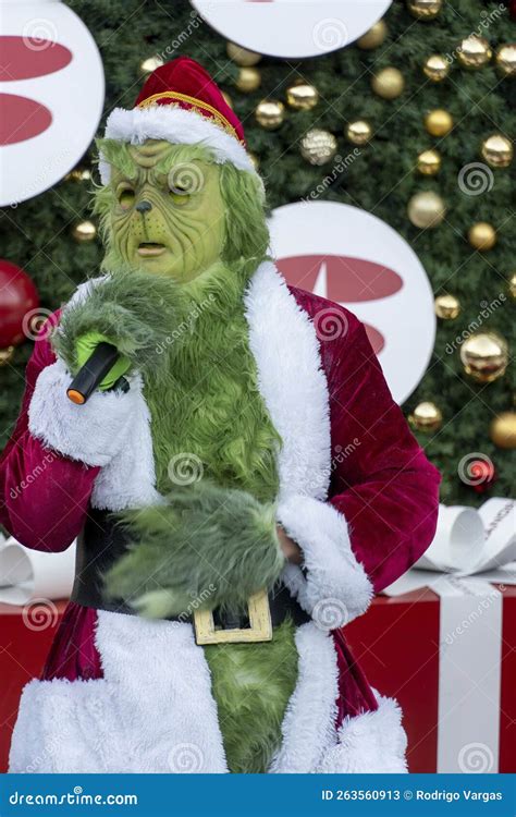 The Grinch Singing and Dancing Behind a Christmas Tree with Big ...