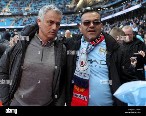 Manchester United Manager Jose Mourinho Poses With A Manchester City Fan Prior To The Premier