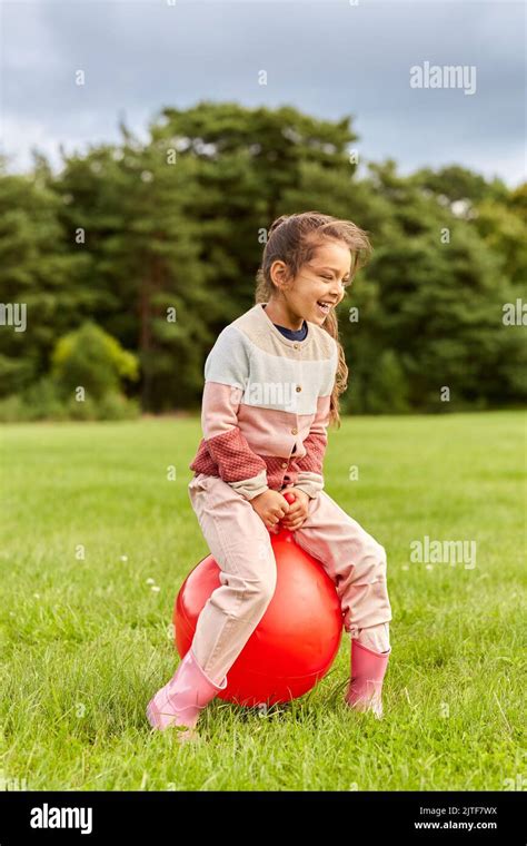 Happy Little Girl Bouncing On Hopper Ball At Park Stock Photo Alamy