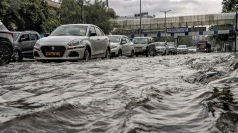 In Photos After Mumbai Delhi Faces Traffic Snarls As Heavy Rain Causes