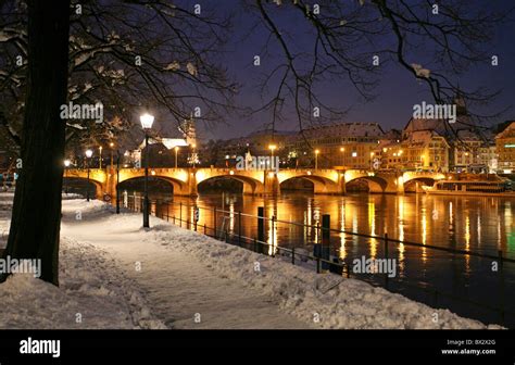 Basel Basle town city at night night winter river promenade snow Rhine Switzerland Europe Stock ...