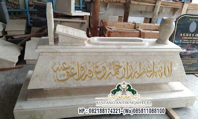 A White Marble Monument With Arabic Writing On The Front And Sides In