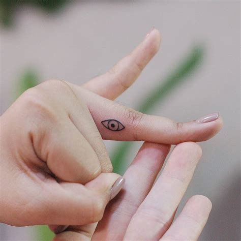 Evil Eye Tattoo On The Finger