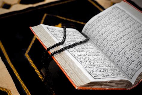 An Open The Holy Quran With Black Tasbeeh The Holy Quran On The Mat Of